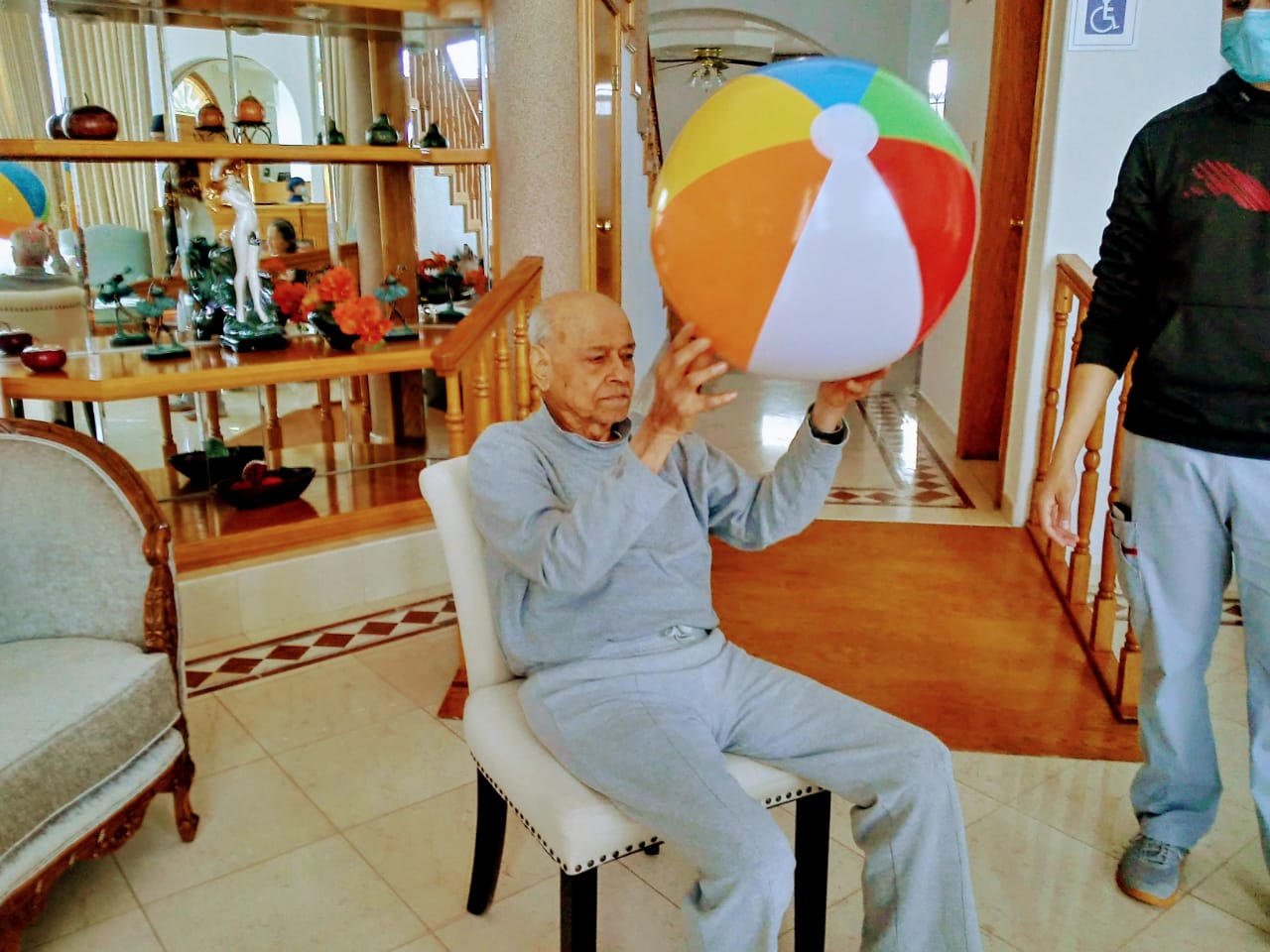 A resident of Casamar in an activity with hi support worker