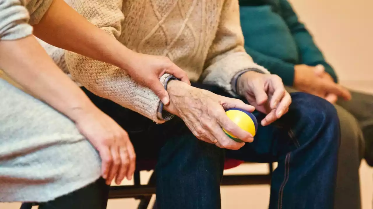 Care giver supporting an old man