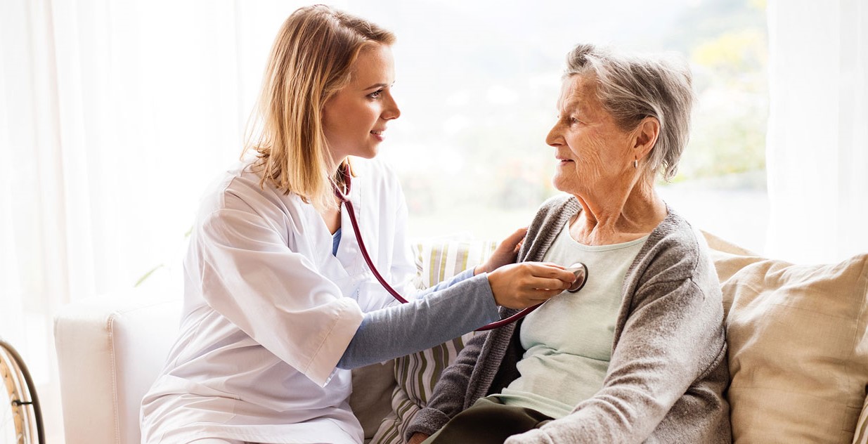 Nurse taking care of an old woman